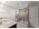 Bathroom featuring granite countertops, a double sink vanity, and glass-enclosed shower with a built-in seat at 232 Providence Ln, Canton, GA 30114