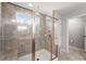 Glass shower enclosure with granite-style tilework and bronze hardware in a modernly designed bathroom at 232 Providence Ln, Canton, GA 30114