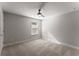 Well-lit bedroom with carpet, a ceiling fan, and a view through the window at 232 Providence Ln, Canton, GA 30114