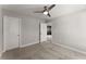 Neutral carpeted bedroom with a ceiling fan and a doorway to the next room at 232 Providence Ln, Canton, GA 30114