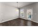 Bright dining area features hardwood floors, a modern light fixture, and a door to the outside at 232 Providence Ln, Canton, GA 30114