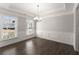 Inviting dining room with coffered ceiling, elegant chandelier, and wainscoting details at 232 Providence Ln, Canton, GA 30114