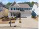 Beautiful two-story home featuring a classic facade, two-car garage, and inviting front porch at 232 Providence Ln, Canton, GA 30114