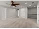 Upstairs hallway featuring neutral carpeting and open view of stairwell and doors at 232 Providence Ln, Canton, GA 30114