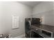 Modern laundry room with a front-load washer and dryer, and utility shelf at 232 Providence Ln, Canton, GA 30114