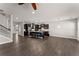 Spacious open-concept living room with hardwood floors and a view of the modern kitchen and staircase at 232 Providence Ln, Canton, GA 30114