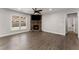 Comfortable living room features a fireplace with stone surround, a ceiling fan and hardwood flooring at 232 Providence Ln, Canton, GA 30114