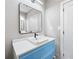 Modern bathroom featuring a stylish blue vanity, sleek mirror, and square sink at 3139 Alston Dr, Decatur, GA 30032