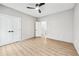 Spacious bedroom featuring wood-look flooring, a modern ceiling fan, and ensuite bath access at 3139 Alston Dr, Decatur, GA 30032