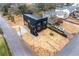 An aerial view shows a modern black home with a newly installed concrete sidewalk at 3139 Alston Dr, Decatur, GA 30032