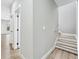 Well-lit hallway and stairs featuring neutral walls and wood-look flooring, providing an inviting transition between floors at 3139 Alston Dr, Decatur, GA 30032