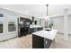 Well-lit modern kitchen featuring a central island with a sink and stainless steel appliances at 3139 Alston Dr, Decatur, GA 30032