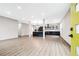 Open-concept living room flows into a modern kitchen, featuring beautiful vinyl floors and neutral walls at 3139 Alston Dr, Decatur, GA 30032