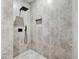 The luxurious bathroom features a spa-like shower with gray tiling and rainfall shower head, creating a serene and tranquil space at 3139 Alston Dr, Decatur, GA 30032