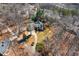 Aerial view of a home nestled among trees, with a circular driveway and well-maintained landscaping at 7452 Mount Vernon Rd, Lithia Springs, GA 30122