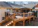 Elevated wooden deck with a stylish outdoor seating area, and shade umbrella at 7452 Mount Vernon Rd, Lithia Springs, GA 30122