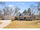 Exterior of home with detached garage; mature trees on a large lot at 7452 Mount Vernon Rd, Lithia Springs, GA 30122