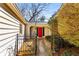 Charming front entrance with a red door, black shutters, decorative archway, and a stone pathway at 7452 Mount Vernon Rd, Lithia Springs, GA 30122