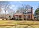 Lovely home features a detached garage, lush yard, and classic brick design at 7452 Mount Vernon Rd, Lithia Springs, GA 30122