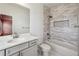 Bright bathroom features a modern vanity and a tiled shower over a tub at 146 Rowan Ave, Alpharetta, GA 30009