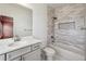 Bright bathroom featuring a shower-tub combo with gray tiled surround and storage niche at 146 Rowan Ave, Alpharetta, GA 30009