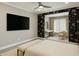 Bedroom and ensuite featuring dark floral wallpaper, a vanity, and ample natural light at 146 Rowan Ave, Alpharetta, GA 30009