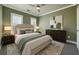 Serene bedroom with soft green walls, neutral bedding, and natural light from shuttered windows at 146 Rowan Ave, Alpharetta, GA 30009