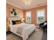Comfortable bedroom with neutral decor, a ceiling fan, and natural light from shuttered windows at 146 Rowan Ave, Alpharetta, GA 30009