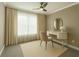 Cozy bedroom with a vanity, plush chair, neutral color palette, and natural light at 146 Rowan Ave, Alpharetta, GA 30009