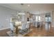 Bright dining area featuring a glass table, white chairs, contemporary lighting, and hardwood floors at 146 Rowan Ave, Alpharetta, GA 30009