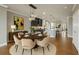 Elegant dining room with hardwood floors, modern lighting, and an open view of the kitchen at 146 Rowan Ave, Alpharetta, GA 30009
