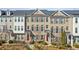 Row of townhouses featuring brick exteriors, symmetrical windows, and well-maintained landscaping at 146 Rowan Ave, Alpharetta, GA 30009
