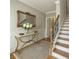 Elegant foyer with a decorative mirror, hardwood floors, staircase, and classic wainscoting at 146 Rowan Ave, Alpharetta, GA 30009