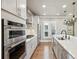 Well-lit kitchen featuring stainless steel appliances and a spacious island with double sinks at 146 Rowan Ave, Alpharetta, GA 30009