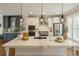 Bright kitchen with stainless steel appliances, large island, and modern pendant lights at 146 Rowan Ave, Alpharetta, GA 30009