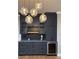 Stylish kitchen with gray cabinets, marble countertops, wine cooler, and pendant lighting at 146 Rowan Ave, Alpharetta, GA 30009