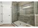 Walk-in shower with glass door, tiled walls, and a built-in bench at 146 Rowan Ave, Alpharetta, GA 30009