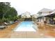 Community pool with lounge chairs and a modern pool house, surrounded by greenery and residential homes at 146 Rowan Ave, Alpharetta, GA 30009
