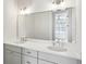 Bright bathroom showcasing a double sink vanity and large mirror at 208 Haralson Ne Ln, Atlanta, GA 30307