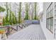 Expansive back deck with decorative railings surrounded by lush trees at 3661 Silver Leaf Sw Ln, Marietta, GA 30008