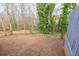 View of the backyard with a tree line in the background and fenced perimeter at 3661 Silver Leaf Sw Ln, Marietta, GA 30008