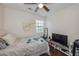 Bedroom featuring wood floors, white walls, a ceiling fan, and comfortable bed near a bright window at 3661 Silver Leaf Sw Ln, Marietta, GA 30008