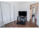 Bedroom featuring wood floors, white walls, closet, and tv setup at 3661 Silver Leaf Sw Ln, Marietta, GA 30008