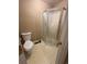 Small bathroom with a corner shower unit and traditional toilet at 4749 Cox Se St, Acworth, GA 30101