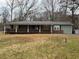 Charming single-story home featuring a covered porch and mature trees in a serene setting at 4749 Cox Se St, Acworth, GA 30101