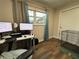 Bedroom with a desk and dual computer monitors, neutral paint and hardwood floors at 62 Place Fontaine, Lithonia, GA 30038