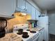 Charming kitchen featuring bright white cabinets, granite countertops, and tile backsplash at 62 Place Fontaine, Lithonia, GA 30038
