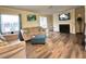 Comfortable living room featuring hardwood floors, stylish furniture, and a cozy fireplace at 62 Place Fontaine, Lithonia, GA 30038