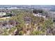 Aerial view showcasing a house sitting on a large, wooded 4.8-acre lot, outlined with approximate lot lines at 105 Leisure Trl, Peachtree City, GA 30269