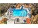 Aerial view of backyard pool with slide, seating, and the home's patio and upper-level deck at 105 Leisure Trl, Peachtree City, GA 30269